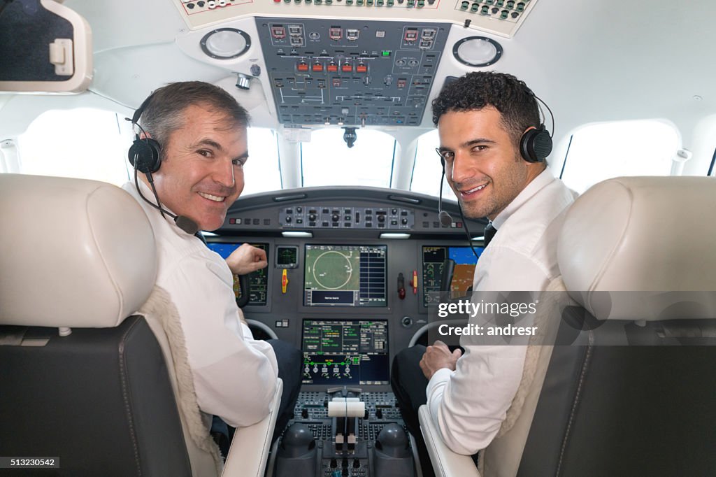 Airplane pilots in the cockpit looking happy