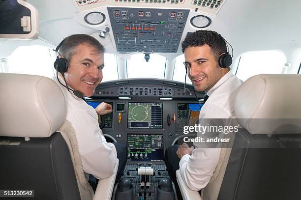 airplane pilots in the cockpit looking happy - co pilot stock pictures, royalty-free photos & images