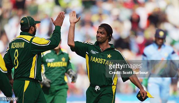 Shoaib Akhtar of Pakistan is congratulated by captain Inzamam-Ul-Haq after taking his fourth wicket during the ICC Champions Trophy match between...