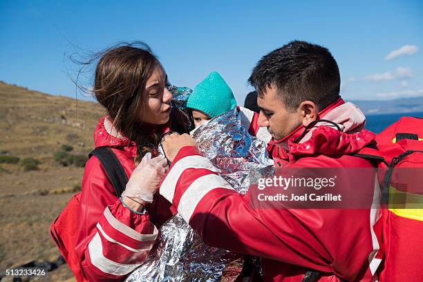 red cross volunteers helping refugees on lesbos - 萊斯博斯島 個照片及圖片檔