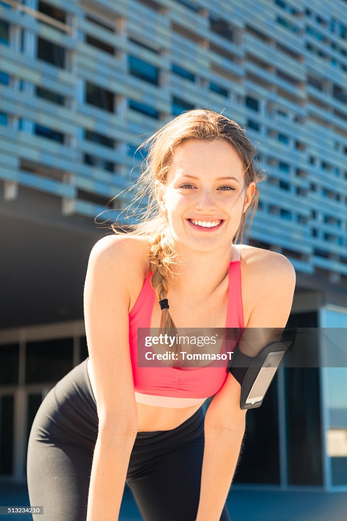 Athlete girl smiling doing jogging outdoor