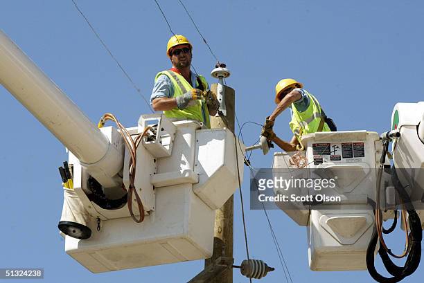 Linemen work to re-establish electricity in the historic district after Hurricane Ivan September 19, 2004 in Pensacola, Florida. Ivan came ashore...