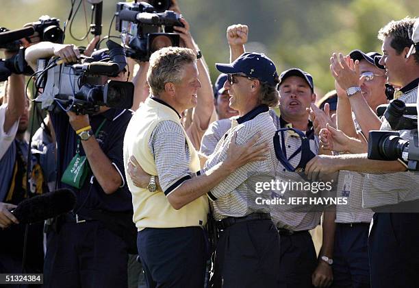 European Ryder Cup golfer Colin Montgomerie of Scotland embraces captain Bernhard Langer of Germany after Montgomerie sank the winning putt on the...