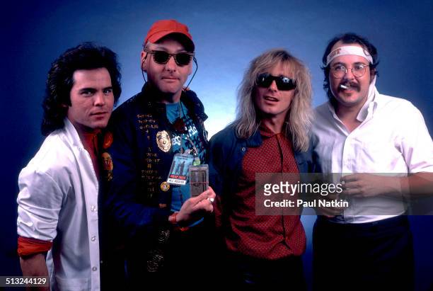 Portrait of, from left, Jon Brandt, Rick Nielsen, Robin Zander, and Bun E Carlos, of the band Cheap Trick, as they pose at the Poplar Creek Music...