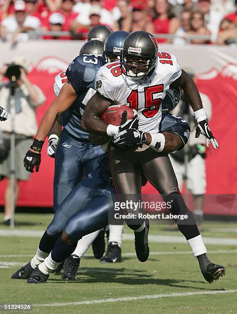 Frank Murphy of the Tampa Bay Buccaneers runs with the ball as the Seattle Seahawks defenders try to block him in the first half of the game on...