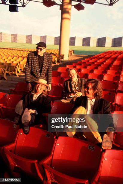 Portrait of, from left, Rick Nielsen , Robin Zander , Bun E Carlos , and Tom Petersson, of the band Cheap Trick, as they pose in the grandstand at...