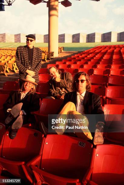 Portrait of, from left, Rick Nielsen , Robin Zander , Bun E Carlos , and Tom Petersson, of the band Cheap Trick, as they pose in the grandstand at...