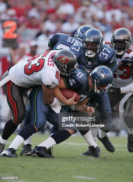 Quaterback Matt Hasselbeck of the Seattle Seahawks gets sacked by Shelton Quarles of the Tampa Bay Buccaneers in the second half of the game won by...