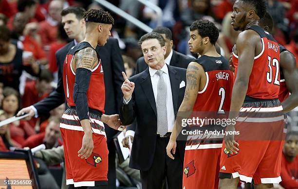 Rick Pitino the head coach of the Louisville Cardinals gives instructions to his team during the game against the Georgia Tech Yellow Jackets at KFC...