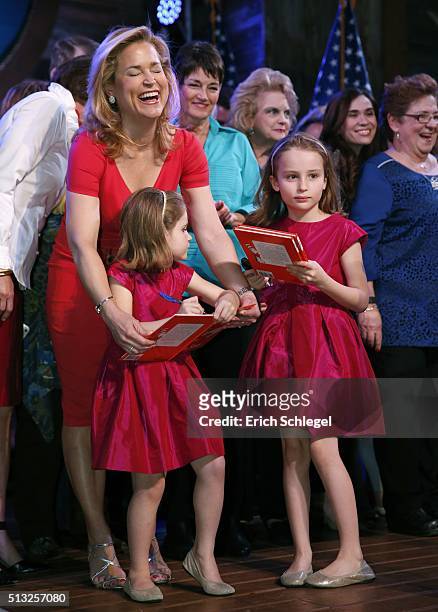 Heidi Cruz laughs as her daughters, Catherine and Caroline autograph two Dr. Seuss books during a Super Tuesday watch party for husband, Republican...
