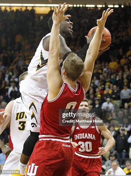 Guard Anthony Clemmons of the Iowa Hawkeyes goes to the basket against forward Max Bielfeldt of the Indiana Hoosiers, in the first half on March 1,...