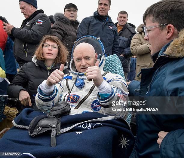 In this handout provided by NASA, Expedition 46 Commander Scott Kelly of NASA rest in a chair outside of the Soyuz TMA-18M spacecraft just minutes...