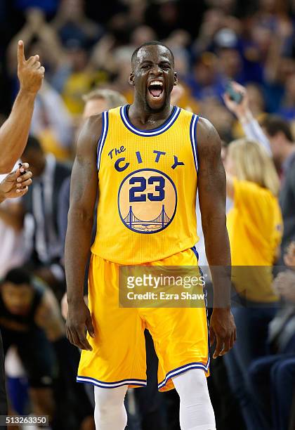 Draymond Green of the Golden State Warriors reacts after making a three-point basket in overtime against the Atlanta Hawks at ORACLE Arena on March...