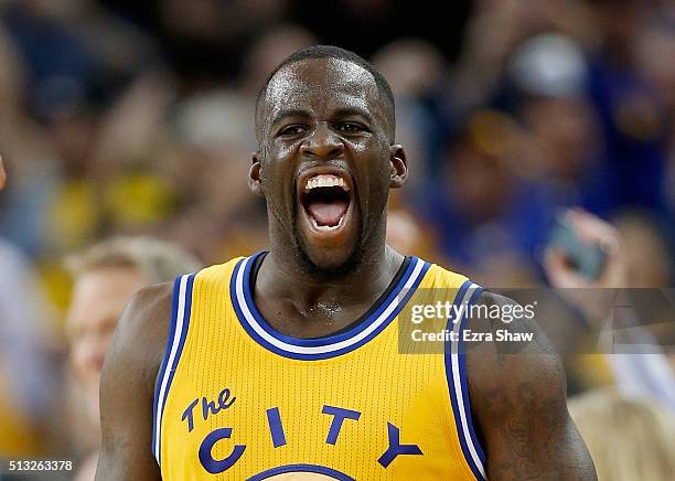 Draymond Green of the Golden State Warriors reacts after making a three-point basket in overtime against the Atlanta Hawks at ORACLE Arena on March...