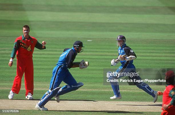 Graeme Hick and Alec Stewart running between the wickets as Heath Streak looks on during the NatWest Series Final between England and Zimbabwe at...