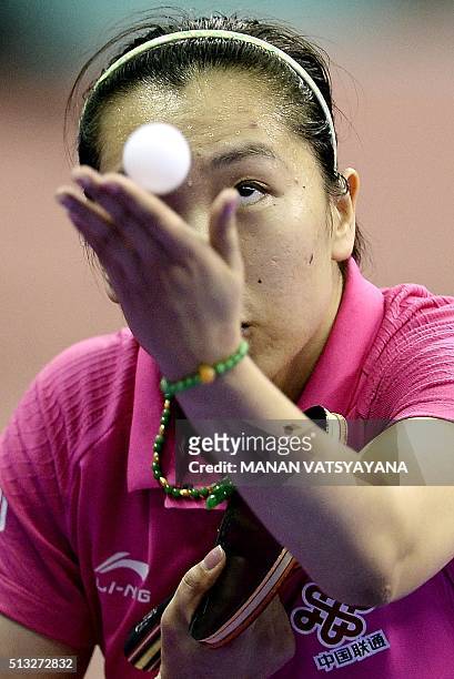 Li Xiaoxia of China serves against Liu Hsing-Yin of Taiwan during their women's singles round match of the 2016 World Team Table Tennis Championships...