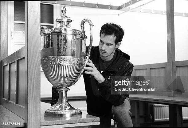 Andy Murray looks at the Aegon Championships trophy at The Queens Club Dressing Rooms on February 26, 2016 in London,United Kingdom. He will try to...