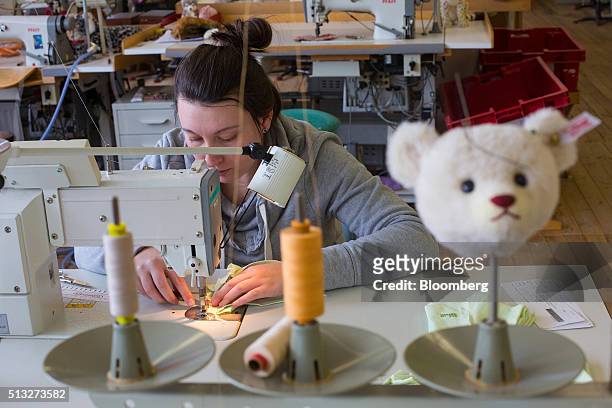 An employee uses a sewing machine during teddy bear manufacture inside the Steiff GmbH stuffed toy factory in Giengen, Germany, on Tuesday, March 1,...