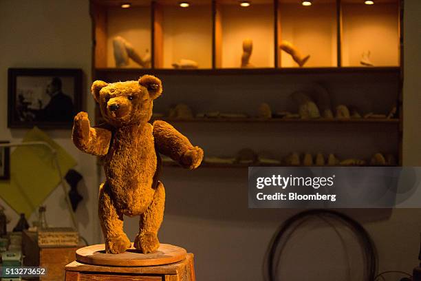 An antique teddy bear sits on display inside the museum at the Steiff GmbH stuffed toy factory in Giengen, Germany, on Tuesday, March 1, 2016. The...