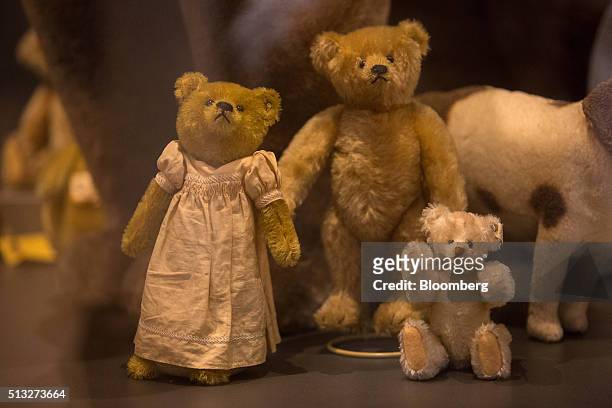 Antique teddy bears sit on display inside the museum at the Steiff GmbH stuffed toy factory in Giengen, Germany, on Tuesday, March 1, 2016. The...