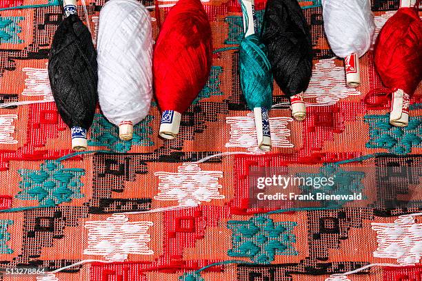 Colorful threads are used at the old traditional looms for weaving the material for the Dhaka topi, the traditional nepali hats.