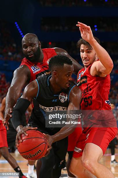 Nate Jawai and Damian Martin of the Wildcats attempt to strip the ball from Cedric Jackson of the Breakers during game one of the NBL Grand FInal...