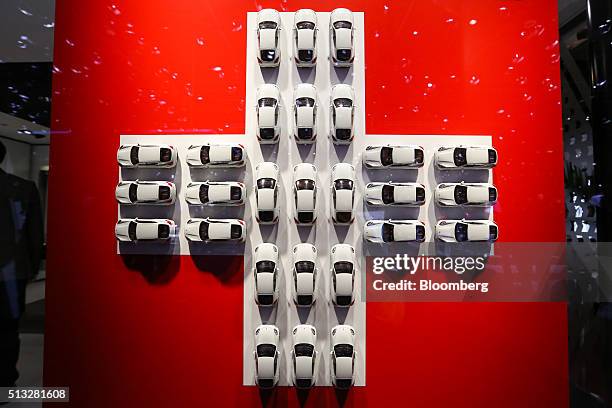 Model white cars sits in a cross formation of the Swiss national flag on the second day of the 86th Geneva International Motor Show in Geneva,...
