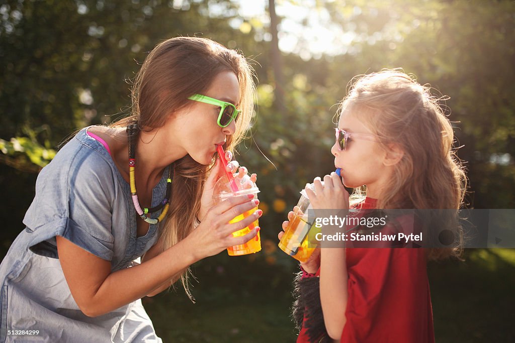 Mother with daughter enjoying bubble tea