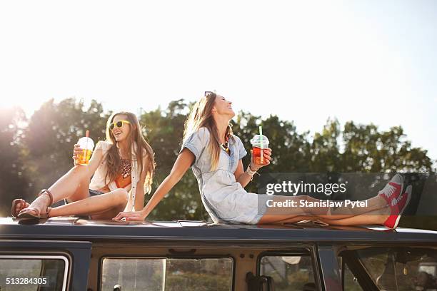 two girls enjoying bubble tea - sitting on top of car stock pictures, royalty-free photos & images