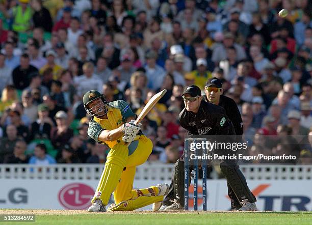 Andrew Symonds of Australia hits Daniel Vettori of New Zealand for 6 during his innings of 71 in the ICC Champions Trophy match between Australia and...