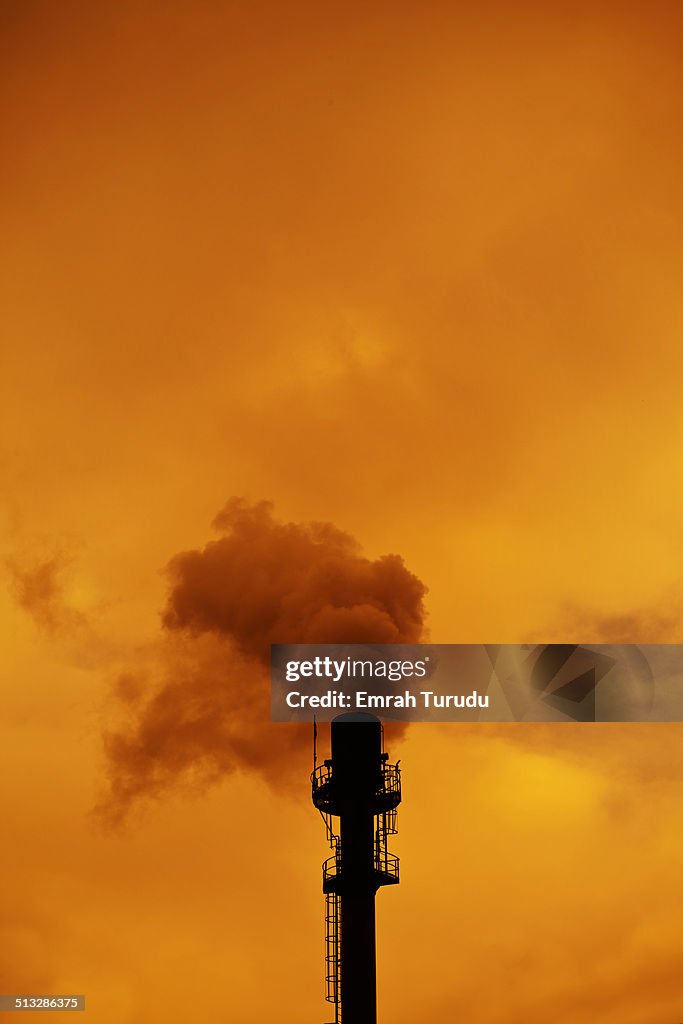 Sunrise and two smokestacks from a powerstation