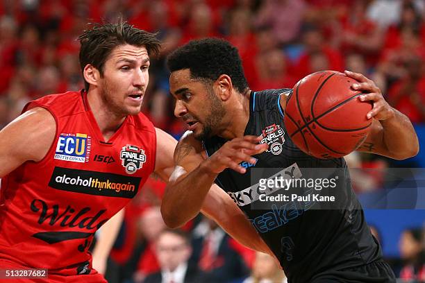 Corey Webster of the Breakers looks drive past Damian Martin of the Wildcats during game one of the NBL Grand FInal series between the Perth Wildcats...