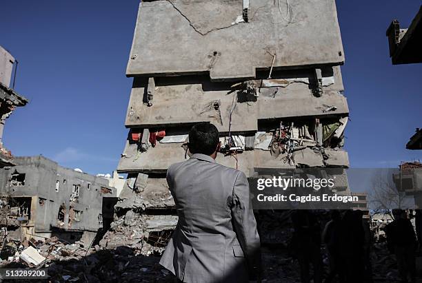 Kurdish man looks the ruined houses and shops in Cizre, March 2 Turkey. Turkish authorities scaled down a 24-hour curfew imposed on the mainly...