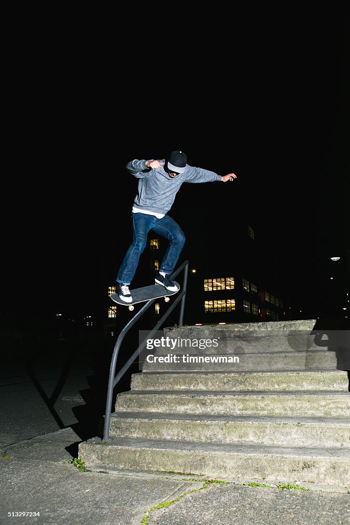 City Skateboarder Skating A Stair Set and Handrail