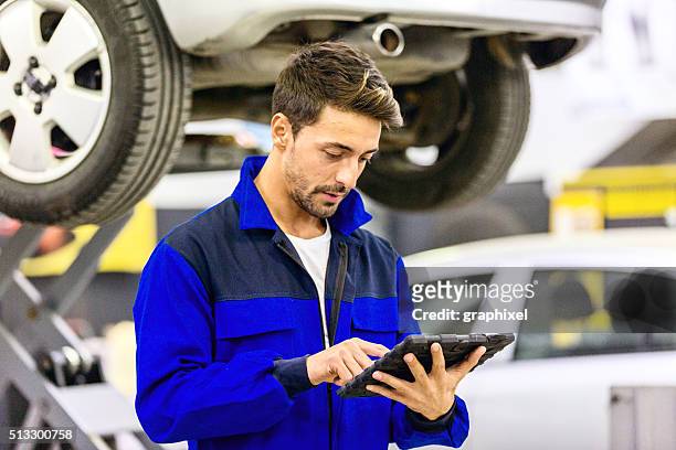 auto mechanic using digital tablet - mechanic tablet stock pictures, royalty-free photos & images