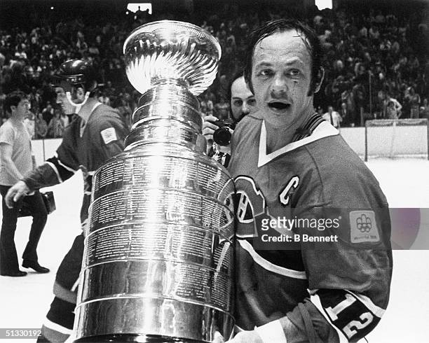 Yvan Cournoyer of the Montreal Canadiens poses for a photo with the Stanley Cup Trophy after winning Game 4 of the 1976 Stanley Cup Finals against...