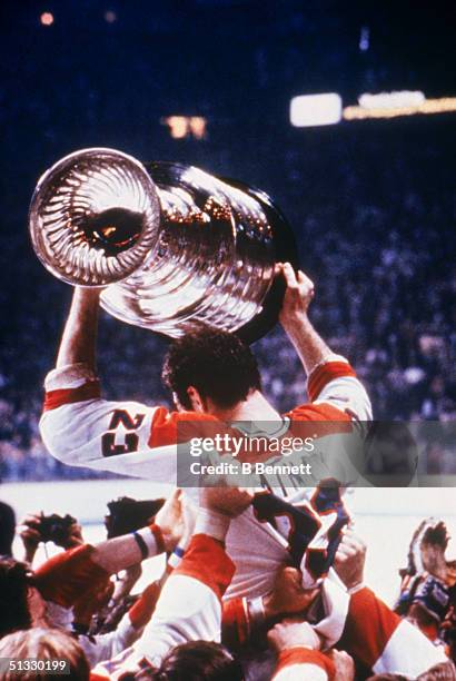 Bob Gainey of the Montreal Canadiens hoist the Stanley Cup as he is being carried by his teammates after defeating the New York Ranges in the 1979...