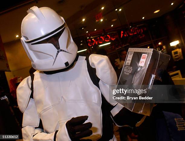 Fan dressed as a clone trooper shows the DVD box set of the Star Wars Trilogy that was released at midnight at Virgin Megastore in Union Square...