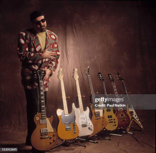 Portrait of American musician Rick Nielsen, of the band Cheap Trick, poses with seven of his guitars, Chicago, Illinois, February 12, 1994.