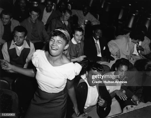 Teenage girl in the audience at 'Big Jay's Bop Session' dances to the music of Big Jay McNeely, 1953.