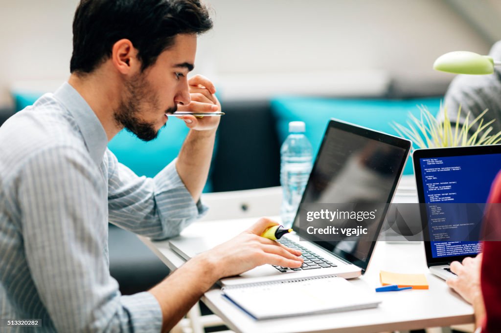 Young Developer Working In His Office.