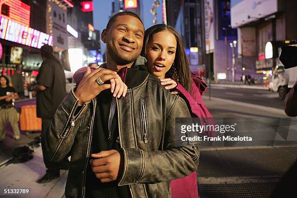Singers Alicia Keys and Usher perform during the filming of Usher's new video for the song "My Boo", in Times Square August 23, 2004 in New York City.