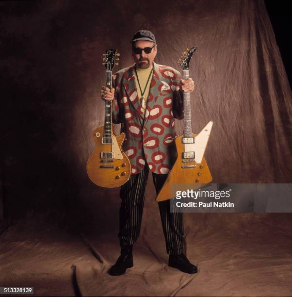Portrait of American musician Rick Nielsen, of the band Cheap Trick, poses with two of his guitars, Chicago, Illinois, February 12, 1994.