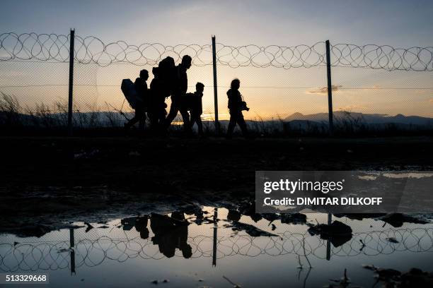 Refugees walk to a registration camp after crossing the border Greek-Macedonian near the town of Gevgelija on March 2, 2016. Macedonia on March 2...