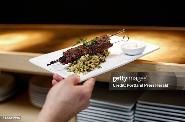 Bo Byrne, exectuive chef at Tiqua, puts out Kefta, a Lebanese dish of spiced ground lamb served with freekah tabouli and minted yogurt, at the...