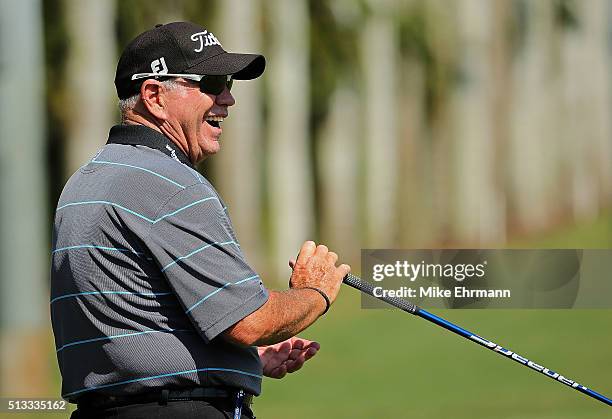 Swing coach Butch Harmon laughs on the range during a practice round ahead of the Cadillac Championship at Trump National Doral on March 2, 2016 in...