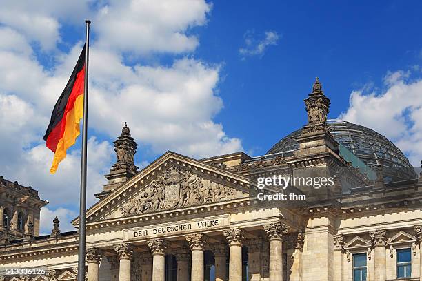 berlin, reichstag building (german parliament building) with german flag - northern european descent stock pictures, royalty-free photos & images