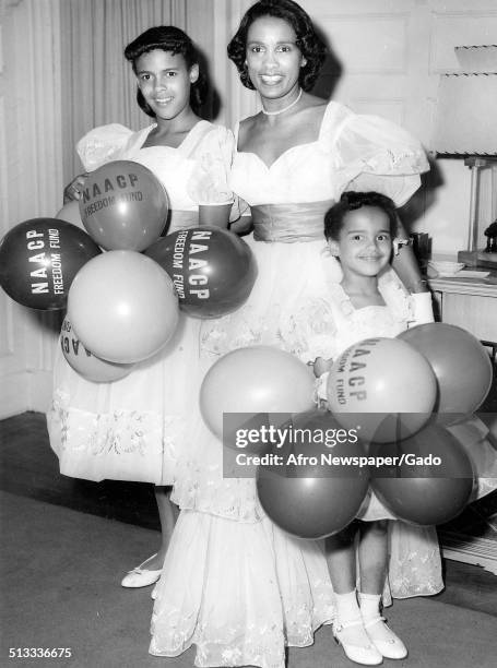 Jazz musician Harry Belafontes wife Marguerite Belafonte and daughters carrying a large number of balloons during an NAACP Freedom Drive, 1958.