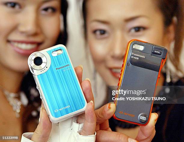 Models display the new three mega-pixel digital cameras "D-snap SV-AS30 and SV-AS3", produced by Japanese electronics giant Matsushita Electric...