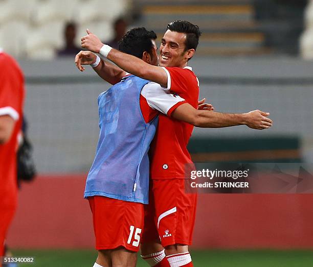 Tractor Sazi's Bakhtiar Rahmani celebrates his goal with a teammate during their Asian Champions League football match against al-Jazira at the...